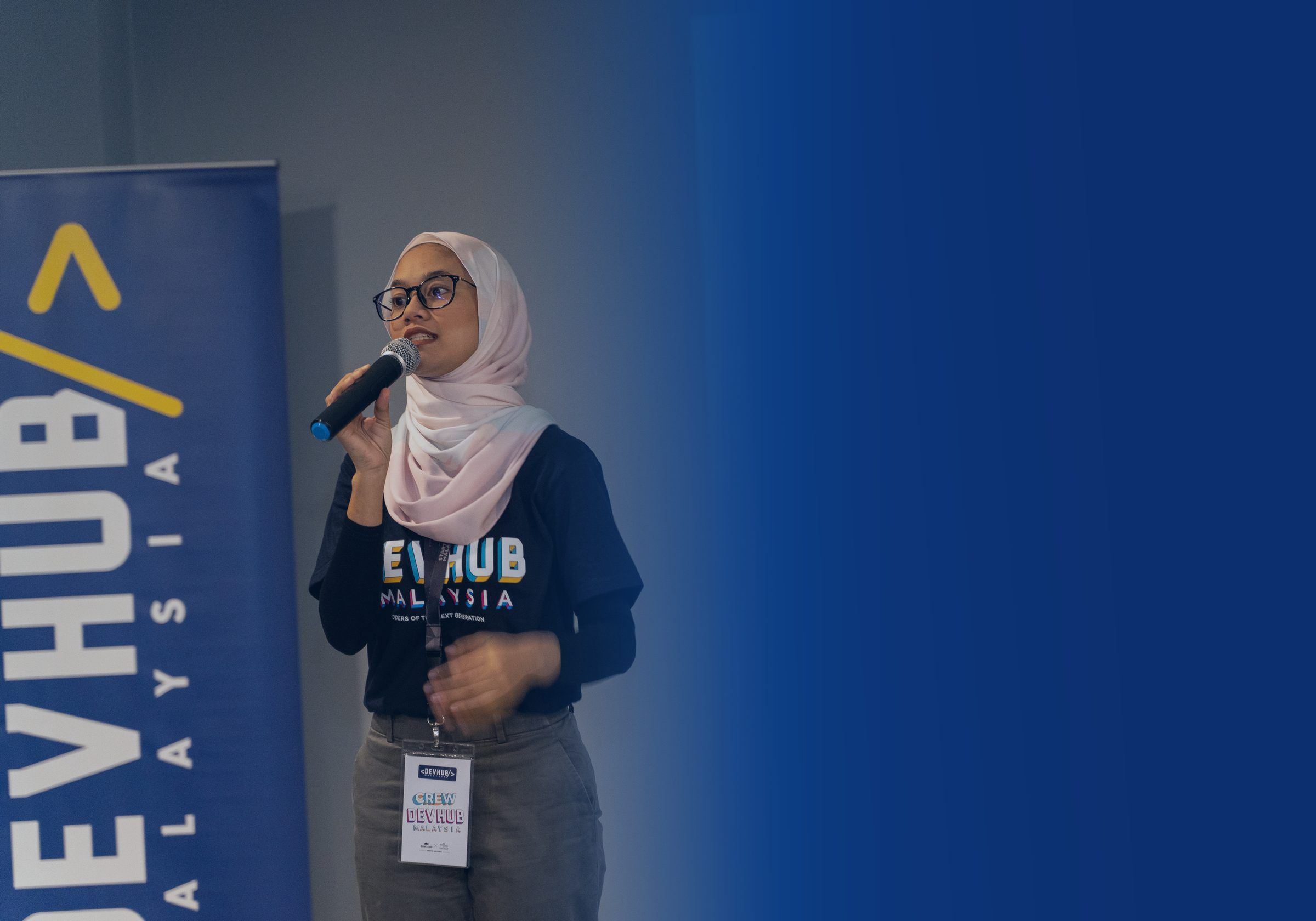 A speaker addressing the audience at a DevHub Malaysia event